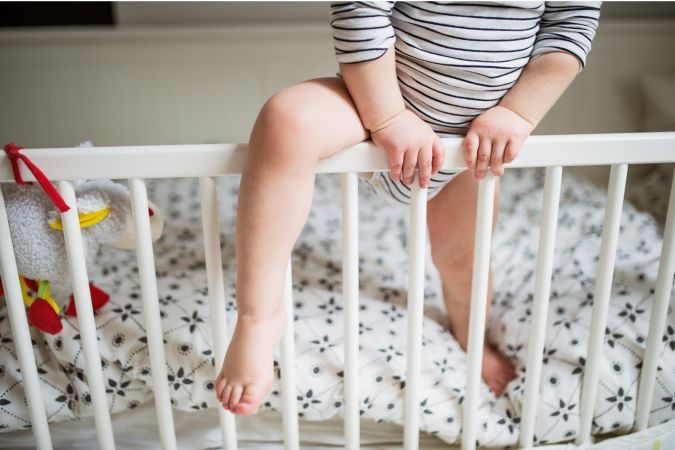 toddler climbing out of crib